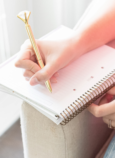 Woman taking notes. How to use a Wheel of Life Assessment to check in on your goals. MarvaSmith.com