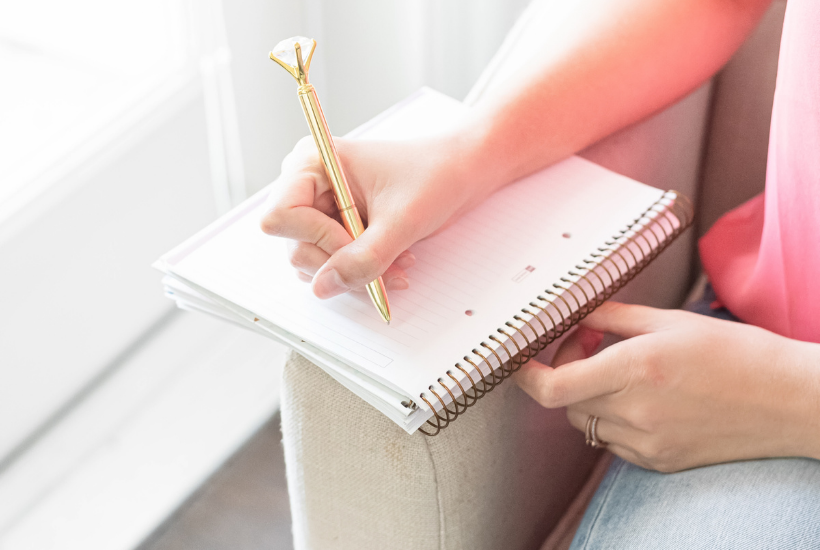 Woman taking notes. How to use a Wheel of Life Assessment to check in on your goals. MarvaSmith.com