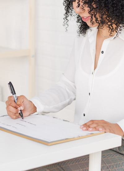 Woman writing on calendar - new year goals.