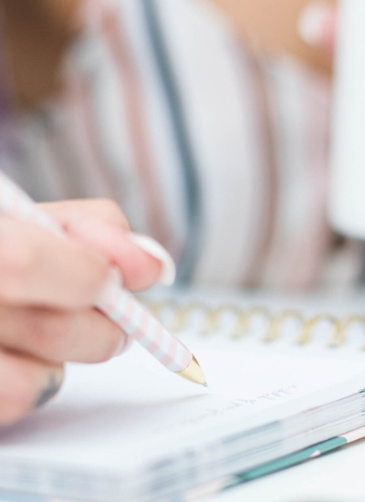 Woman holding mug and writing in journal. Spiritual Practices for Soul Care article by Marva Smith